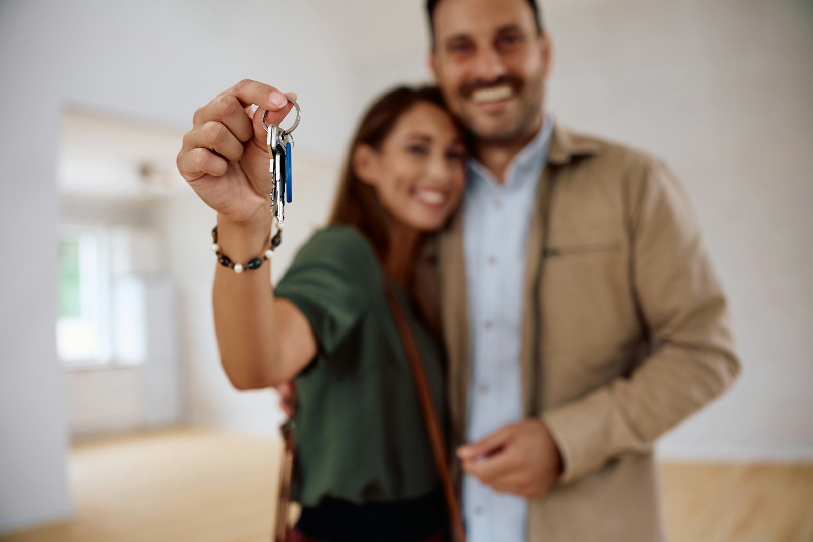 Close up of couple with keys of their new apartment.