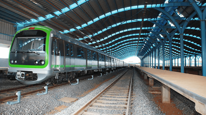 A metro train traveling along the tracks, showcasing connectivity and transport options in Electronic City.
