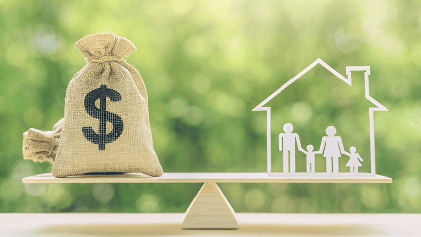 A balance scale featuring a money bag and a house, set against a blurred background, symbolizing affordable housing for families.