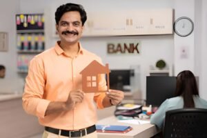 A man is holding house model in bank while choosing the right bank for home loan in India