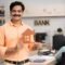 A man is holding house model in bank while choosing the right bank for home loan in India